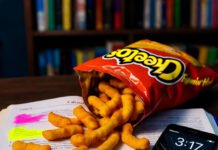 The Ultimate Guide to Study Techniques for Exam Success Cheetos spill on calculus book, phone at 2%