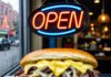 Creative Ideas for Starting Your Own Business: Tips from Successful Entrepreneurs Half-eaten cheesesteak, greasy keyboard, flickering neon "OPEN" sign.