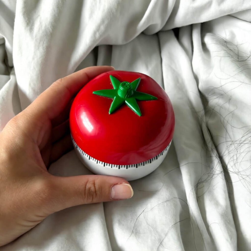 Tomato timer in shaky hand.